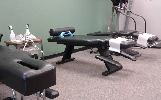 Chiropractic room with multiple padded adjustment tables